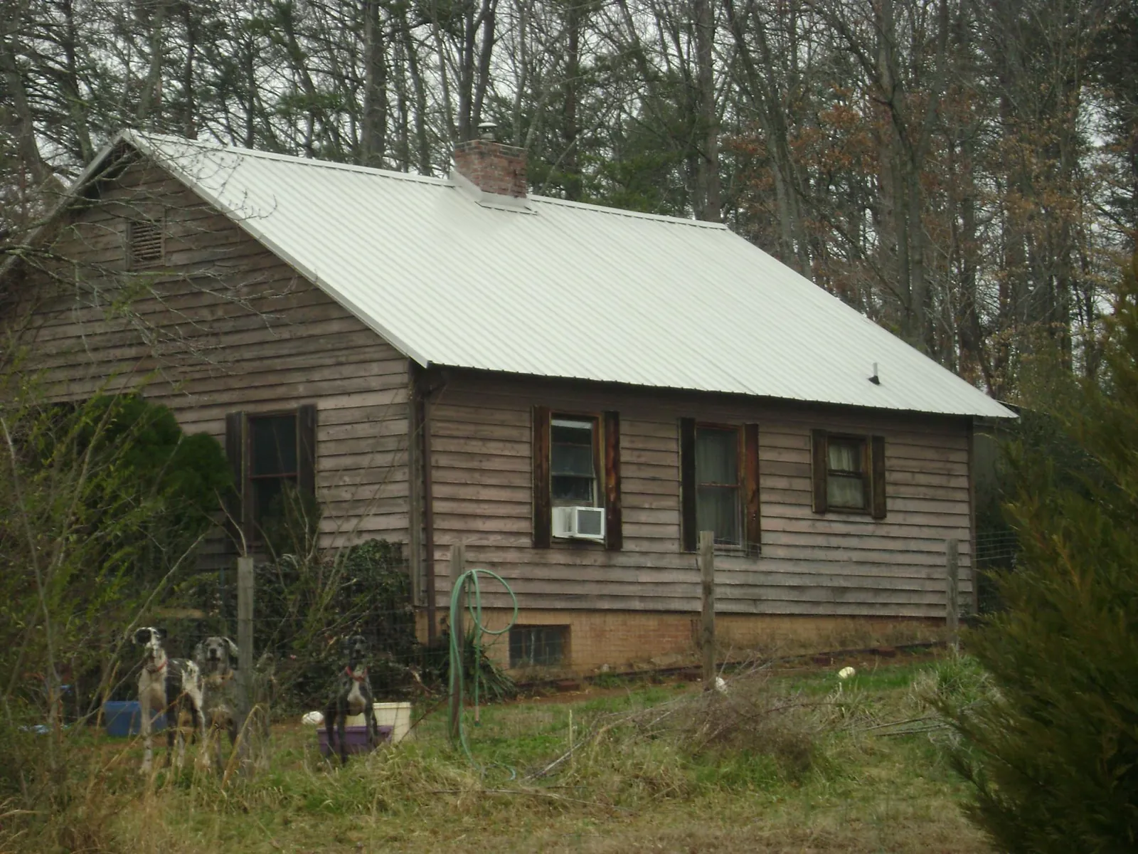 White metal roof on an old wood sided farmhouse, from a Metal Roof Installation job in Hampton Bays